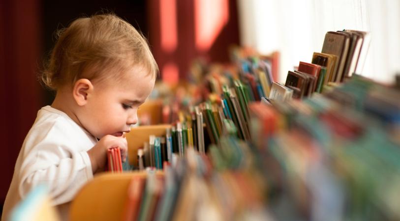 baby looking through books