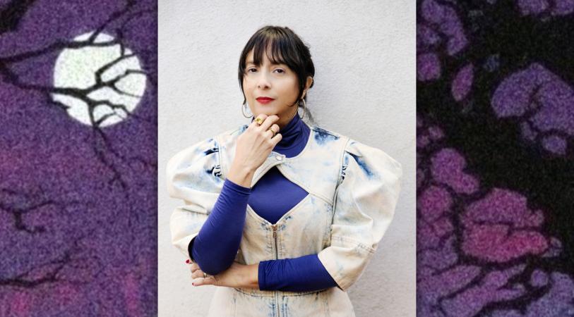 A person in a blue top and light denim jacket poses with one hand near the chin against a plain wall, with two side panels showing a purple patterned background.